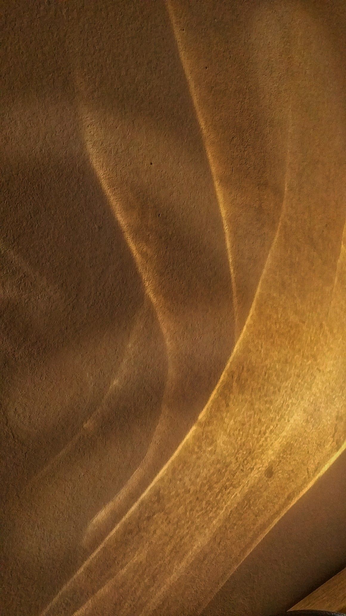 Abstract warm plaster wall with sweeping light